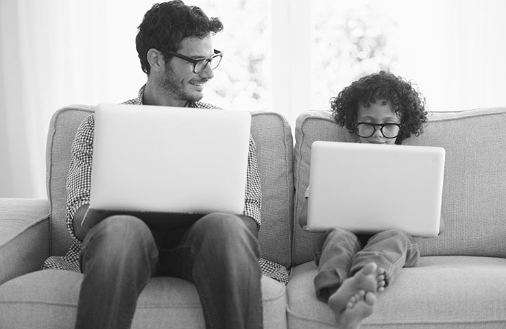 Adult and child using a laptop and tablet