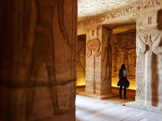 Lady in a musem looking at hieroglyphics structures