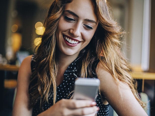 Lady smiling at her phone