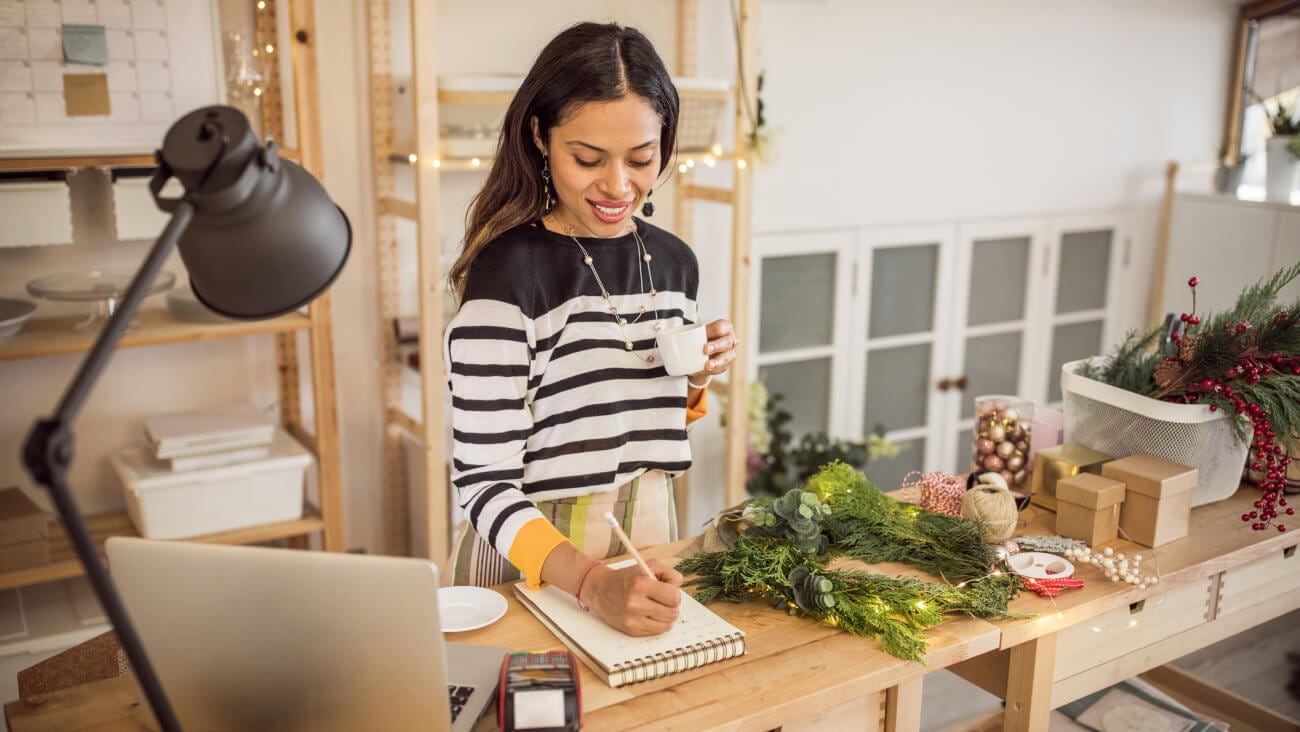 Women filling out her business plan checklist