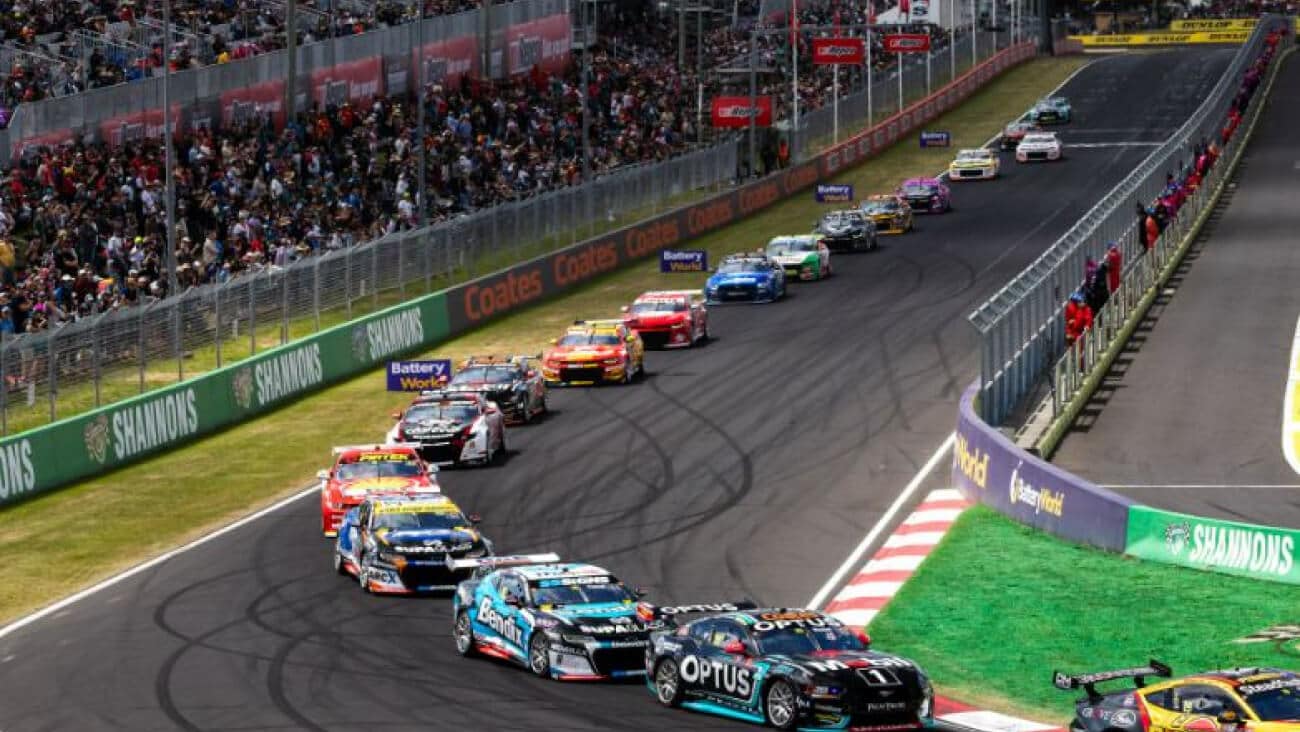 The participating cars driving down the straight in single file at the Bathurst 1000 2024