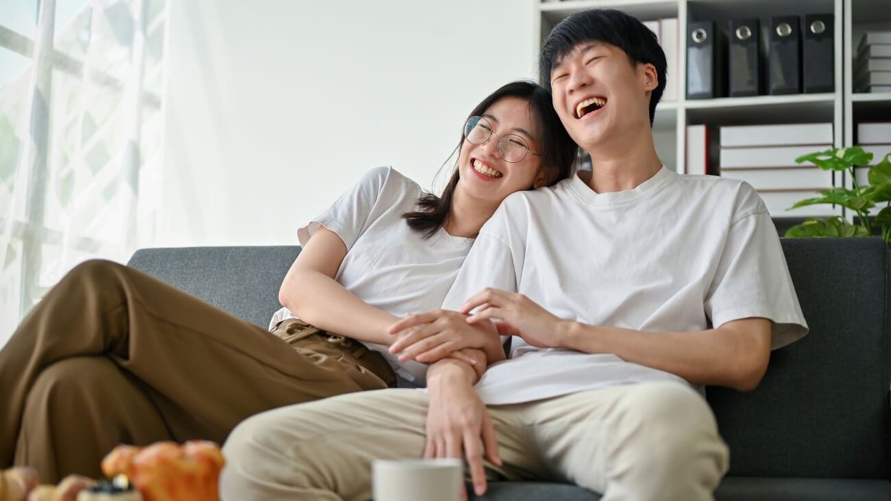 An Asian couple laughing and smiling