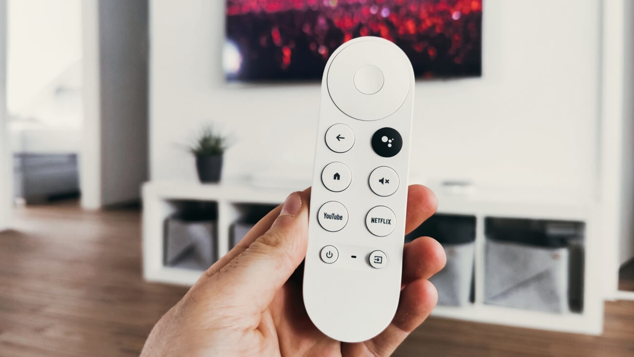 person holding white remote control