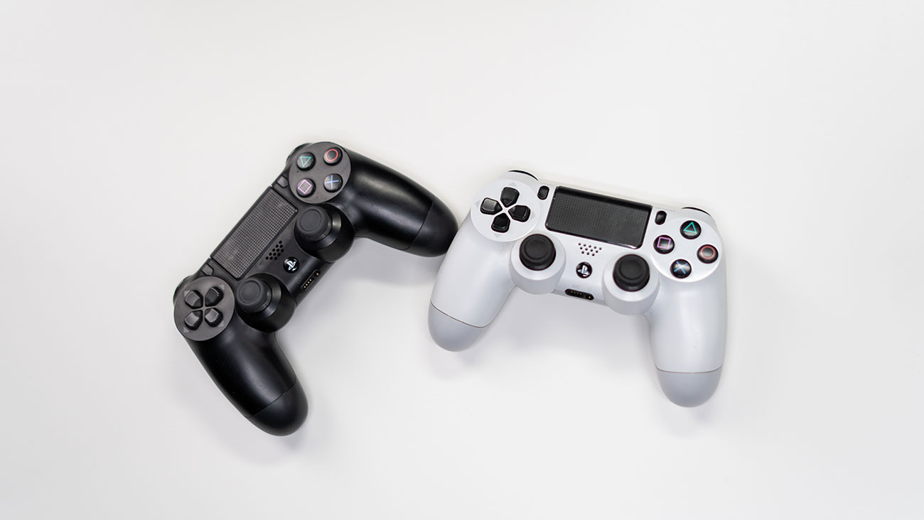 Two PlayStation consoles, one black and one white, featured against a white background.