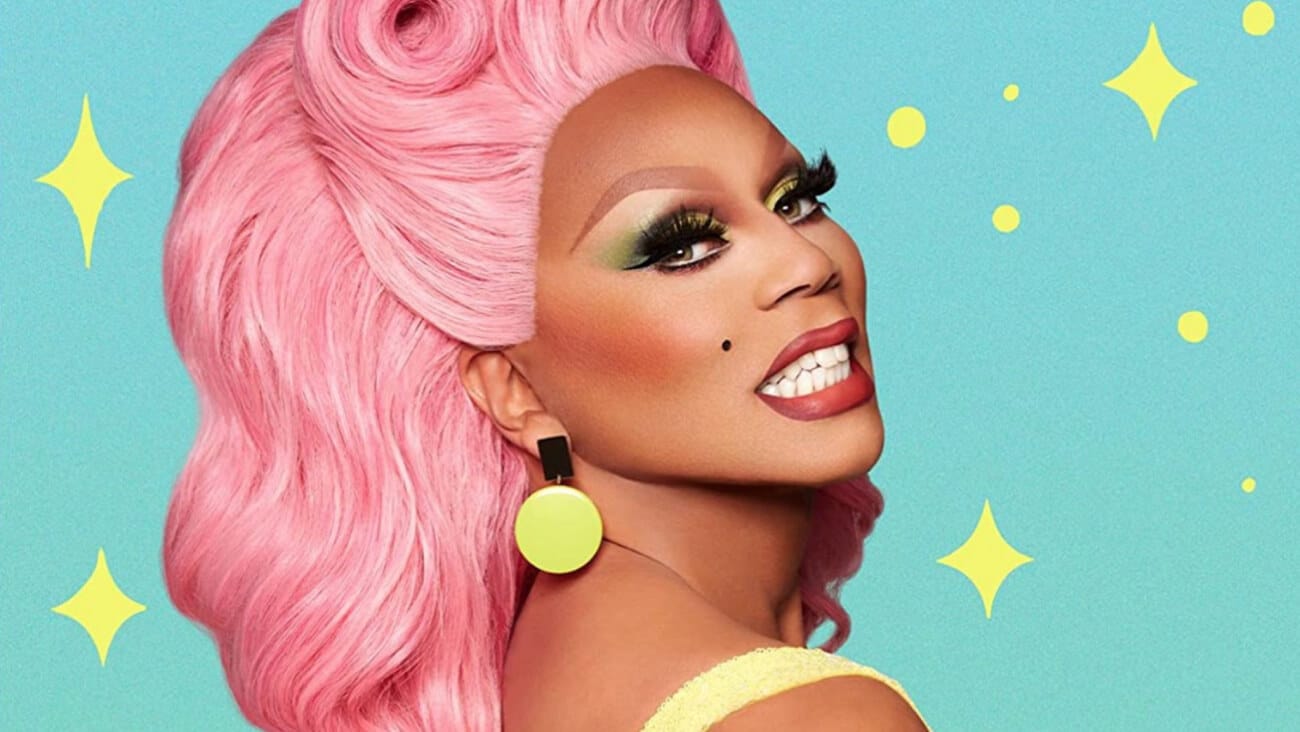 RuPaul in drag smiling at the camera