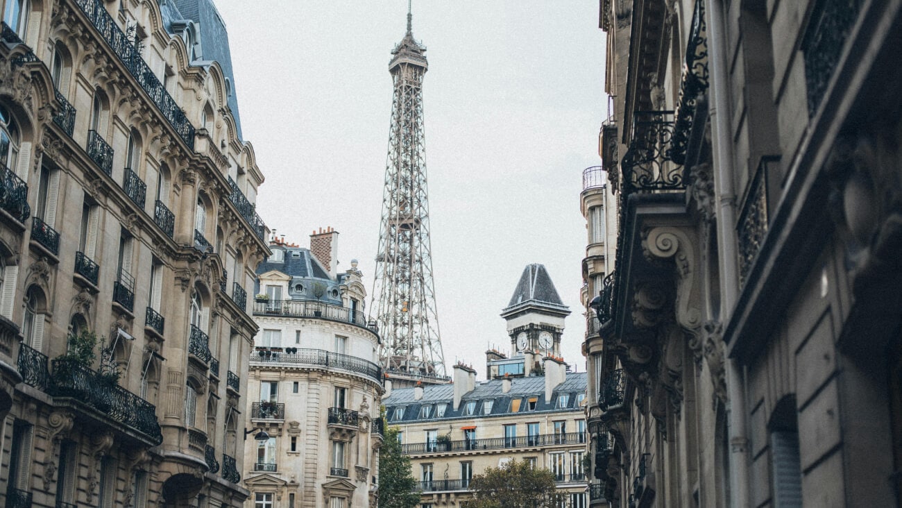 A street scene in Paris with the Eiffel Tower in the background.