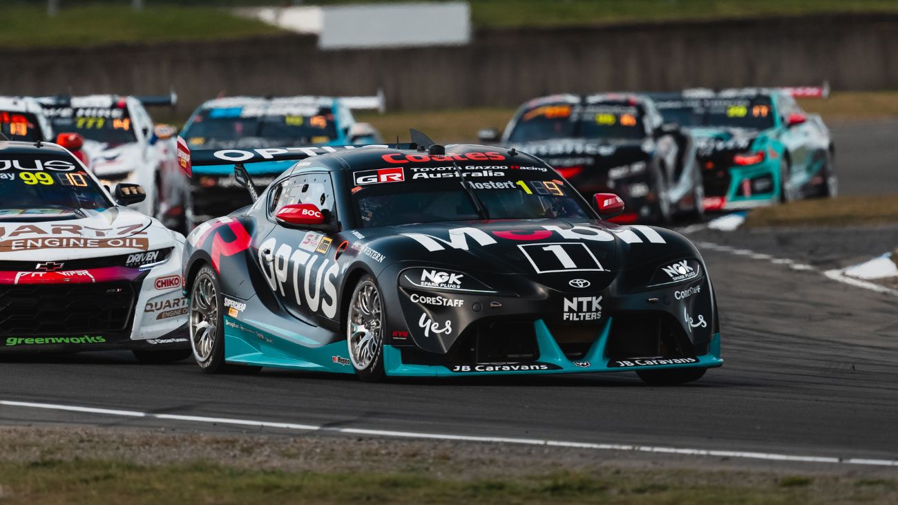 A racing car with Optus livery driving on a racetrack