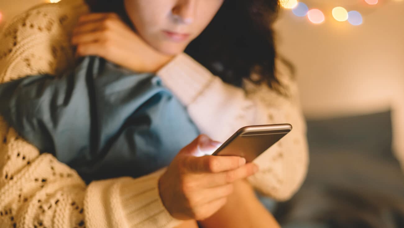 young girl holding a phone while sitting