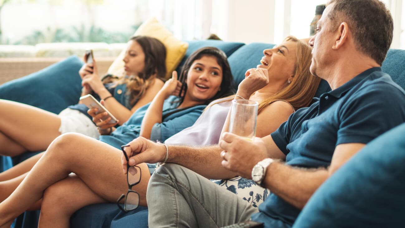 A group of people conversing on a couch