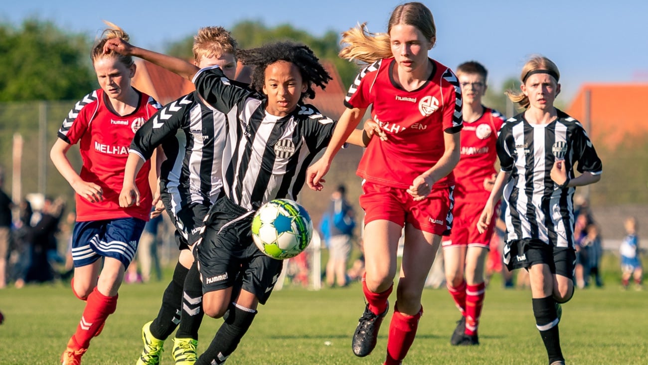 Kids playing football in the field