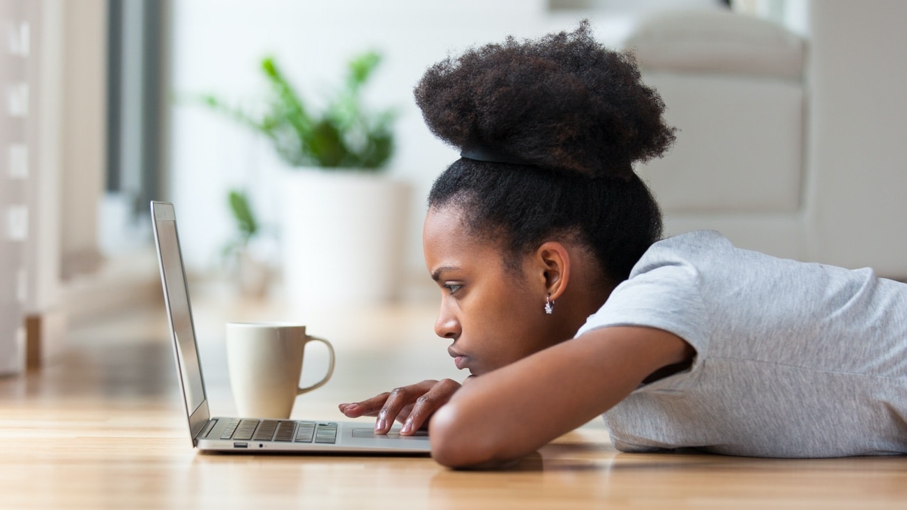 Girl laying down looking at laptop
