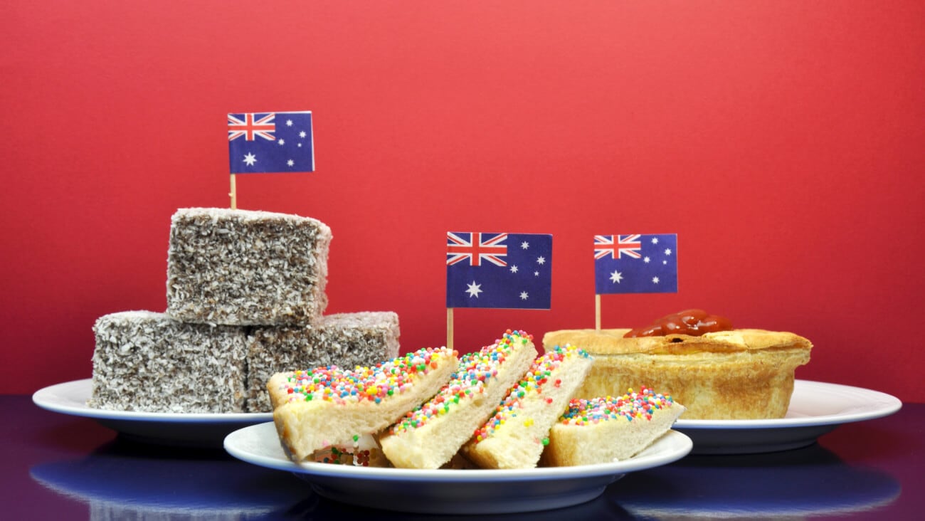 Aussie foods with Australian flags including meat pie, fairy bread and lamingtons