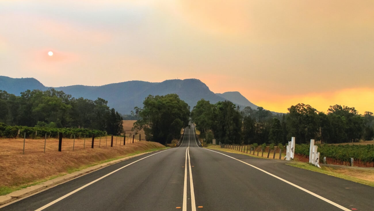 View of Australian road trip scenery at sunset with mountains in the background