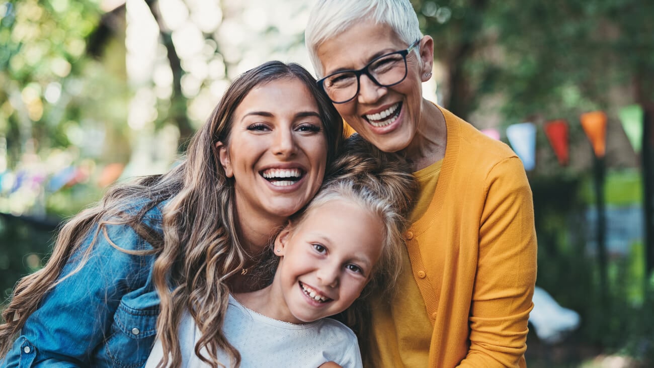 Portrait of happy grandma, mum, and young daughter