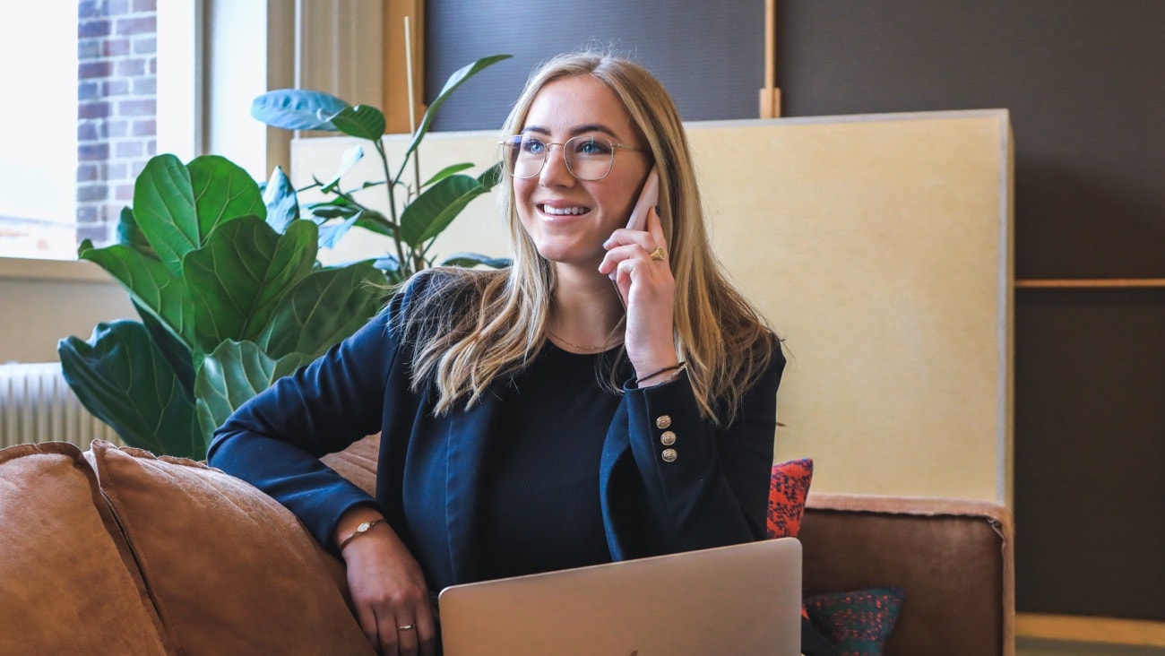 Smiling woman holding a mobile phone