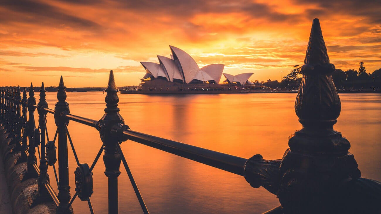 sunrise behind the Sydney Opera House seen from Circular Quay, Sydney, Australia.