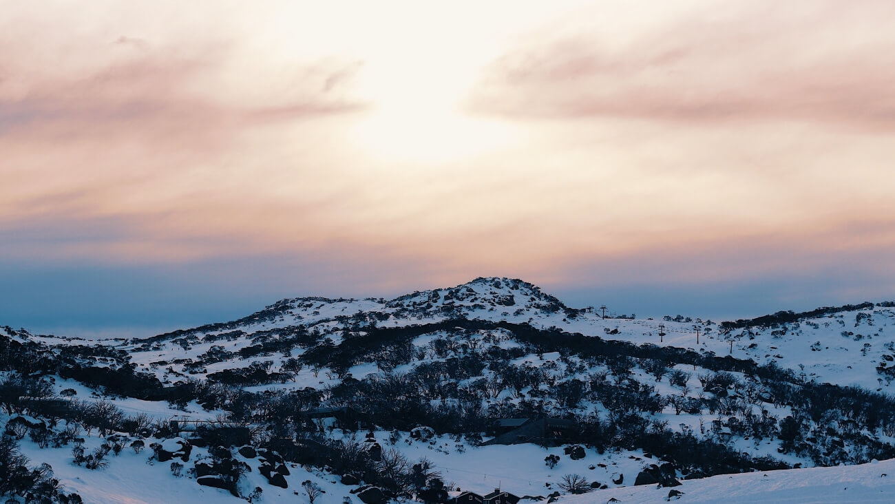 Pink sky and snowy mountains at Perisher Valley in New South Wales