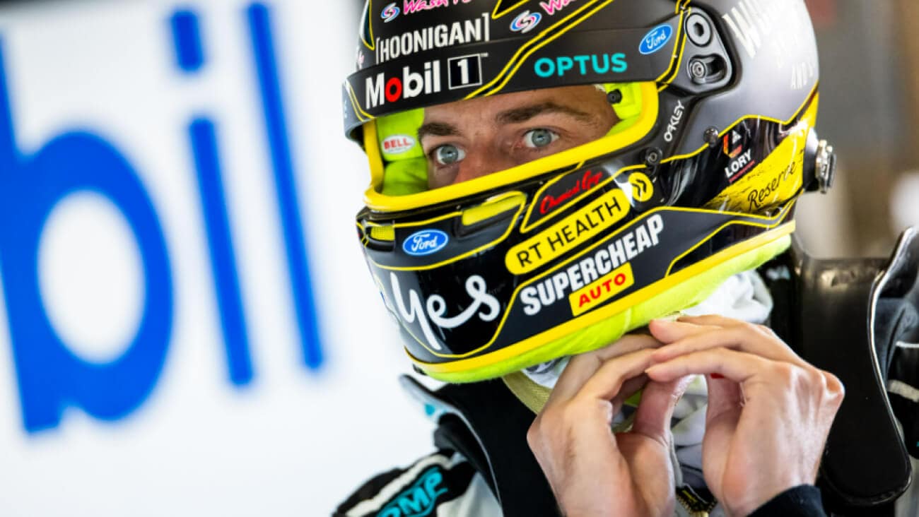 Close up of Chaz Mostert in his racing helmet.