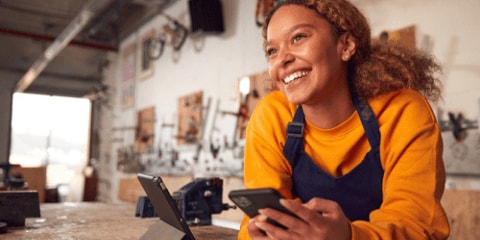 smiling women using tech for work