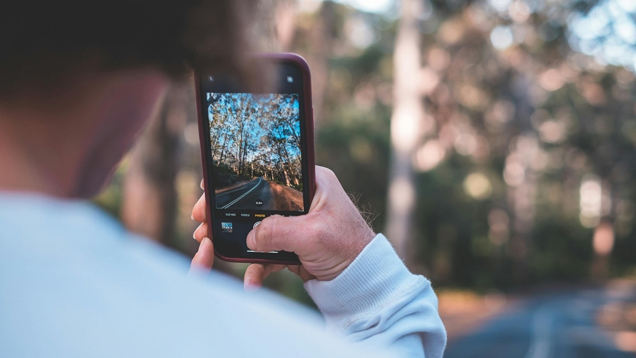 Man using a mobile phone in a remote location in the Australian bush.