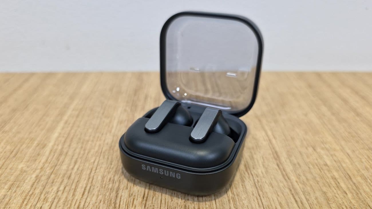 The Samsung Galaxy Buds4 Pro in a charging case on a wooden table
