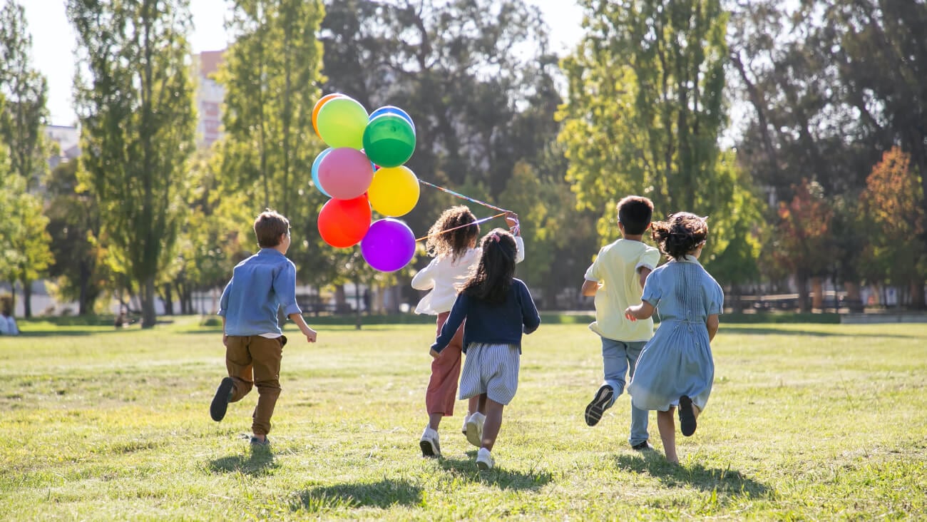 young children running at a park