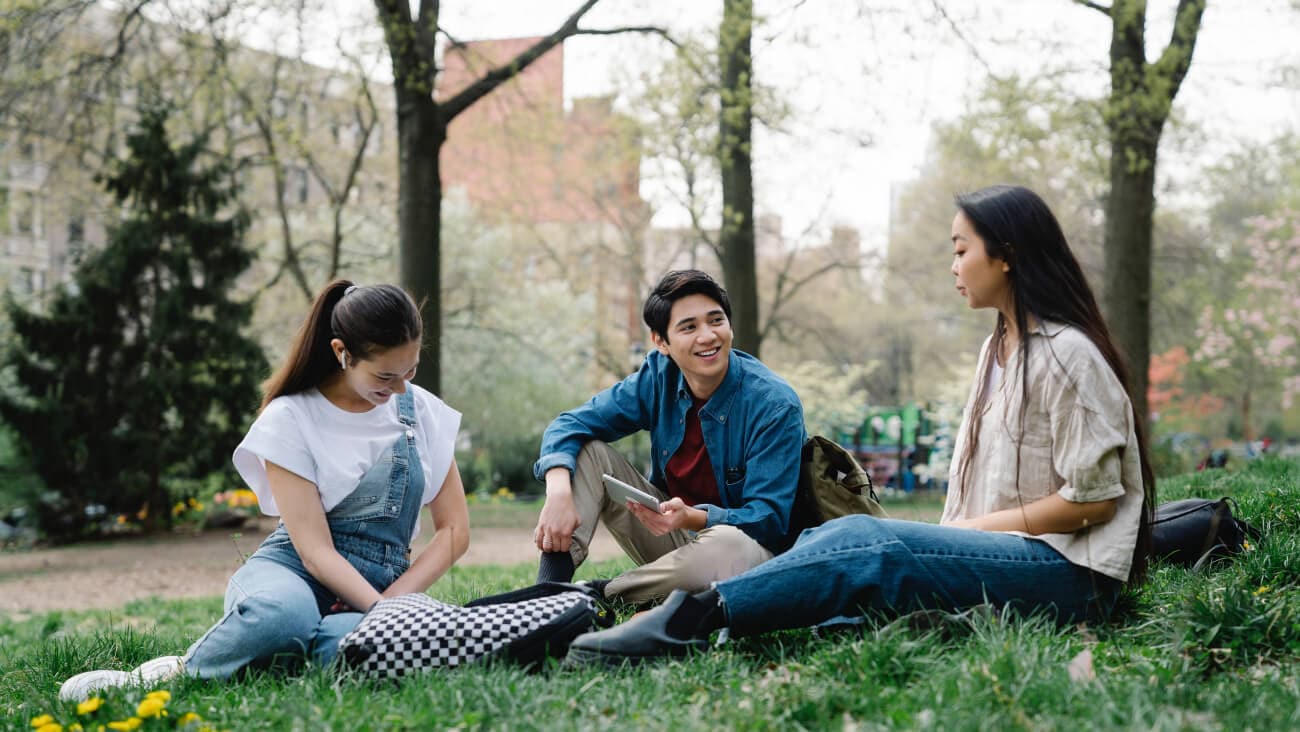 group of students sitting on grass