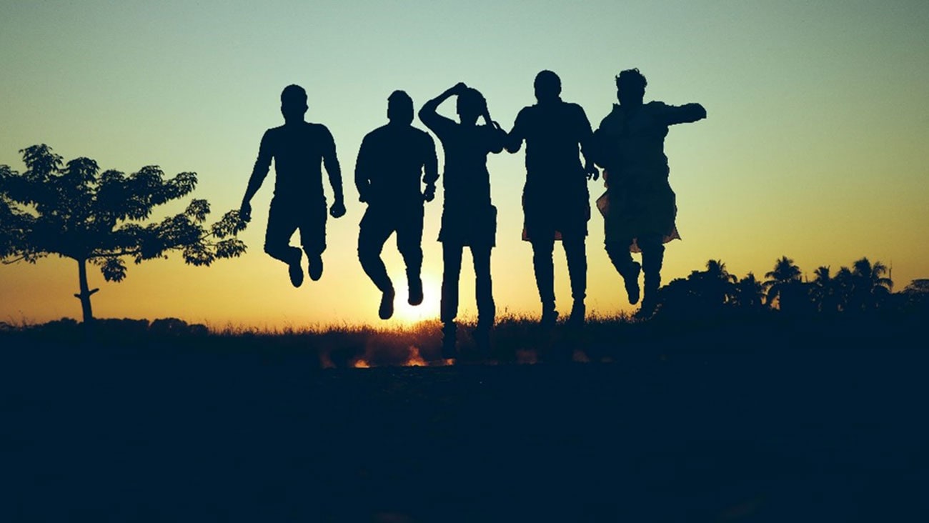 A group of people exercising at sunrise
