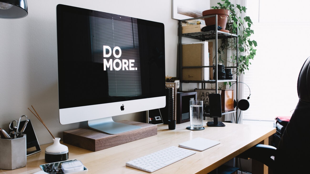 Home office desk and iMac screen that reads Do more.