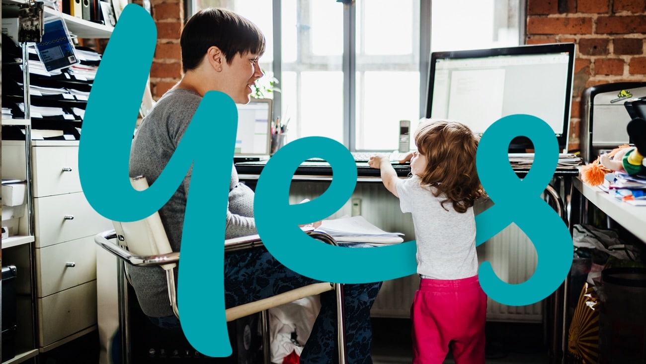 A mother working from home with a toddler