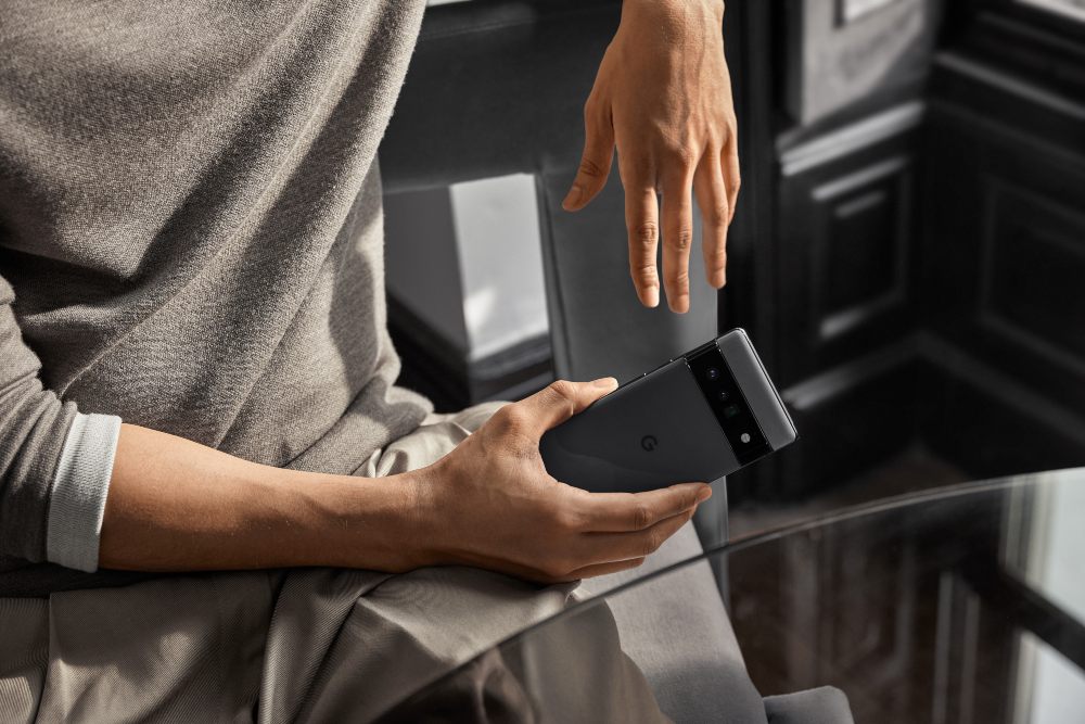Image of a young man holding a phone
