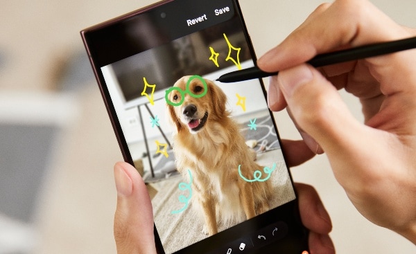 A person drawing on a photo of a dog using the S Pen on the S22 Ultra.