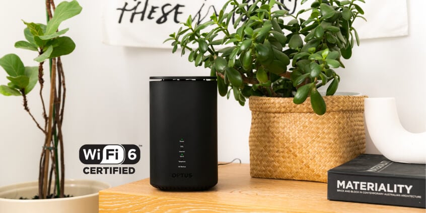 Optus WiFi 6 Modem on benchtop with plants in background