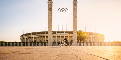 Olympic Stadium Berlin with a female bike rider in the foreground