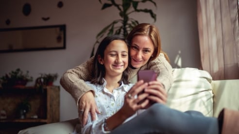 Mother and daughter looking at a mobile phone