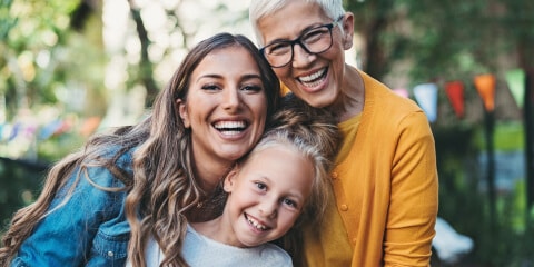 Portrait of happy grandma, mum, and young daughter