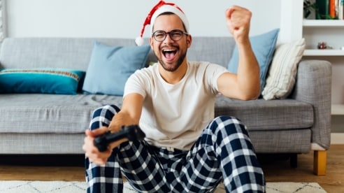 Man holding gaming controller Man holding gaming controller